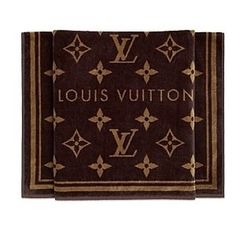 two louis vuitton napkins in brown with gold foil on the front and bottom