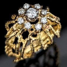 This dazzling 18k gold cocktail ring is a treasure from the late 1960s, showcasing a blend of sophistication and avant-garde design. Fashioned from 18k gold, its commanding dome shape is accented by a spectacular openwork design, marrying lightness with luxury. In a blend of sophistication and avant-garde design, glimmering cluster of diamonds punctuate the intricate gold framework, highlighting the ring's dynamic texture. This piece not only embodies the classic cocktail style of the swinging '60s but also foretells the revolutionary, free-form designs that would come to define the following decade Metals: 18k gold Markings: unmarked, metal tested with acid Gemstones: diamonds Ring Size: 6 Total Weight: 8.2 grams Measurements: 1 1/4 x 1 inch ring top, 3mm wide base of the shank Condition: Luxury Vintage Yellow Gold Diamond Ring, Luxury Exquisite Gold Cluster Ring, Swinging 60s, Classic Cocktail, Late 1960s, Gold Cocktail Ring, Dome Ring, Gold Cocktail, Diamonds Ring