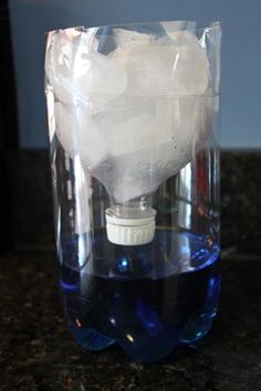 a light bulb in a plastic container on a counter top with ice cubes around it