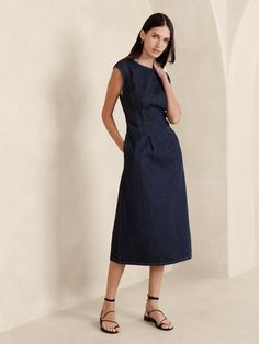 We reimagined the classic shift dress in a versatile, lightweight denim fabric we sourced from Italy.  Here, we added subtle cap sleeves and darts to shape the waist for an almost corset-like silhouette.  Fit and flare.  In-Conversion Cotton: Banana Republic is committed to sourcing organic cotton, as well as in-conversion cotton to support growers as they transition to certified organic farming methods, a process that can take up to 36 months.  Crew neck.  Invisible zip at back.  Side seam pockets.  Unlined.  Fit and flare.  Short sleeves.  Midi length.  Model: Size 2, 5'10" (178cm). Latest Summer Fashion, Denim Midi Dress, Dress Shirt Sleeves, Summer Fashion Trends, Organic Farming, Everyday Dresses, Denim Fabric, Denim Dress, Fit And Flare