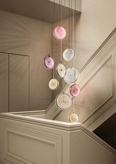 a bunch of donuts hanging from the side of a stair case in a house