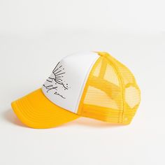 a yellow and white hat with an image of a bird on it