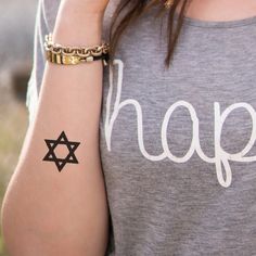 a woman with a star of david tattoo on her arm and the word hope written in hebrew