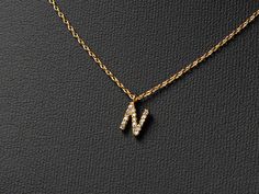 "Mini paved initial necklace makes a unique and personalized gift that sure to surprise and delight just about anyone on your list. 🤍This stylish pendant necklace features a mini monogram with bamboo textured initial is an ideal gift for moms, sisters, daughters, hostesses - and even yourself! - it's a way to reflect one's individuality with an added touch of charm.   🤍Size:  Chains- 16 \"with 2\" extension Pendant: 0.2\" height and 0.2\" wide. 🤍Our jewelry comes in gift boxes. You can add pe N Necklace, Initial N, Monogram Pendant, Letter N, Fancy Jewellery, Birthday Gift For Her, Necklace Personalized, Birthday Gifts For Her, Name Necklace