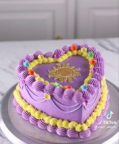 there is a heart shaped cake with decorations on the top and bottom, sitting on a plate