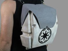 a person wearing a backpack with a star wars symbol on it