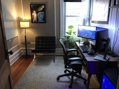 a room with a desk, chair and computer on it