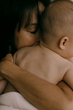 a woman holding a baby in her arms