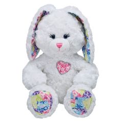 a white stuffed rabbit with floral designs on it's ears