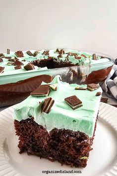 a slice of chocolate cake with mint frosting on a plate