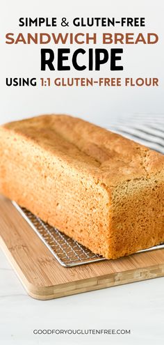 a loaf of bread sitting on top of a wooden cutting board next to a cooling rack