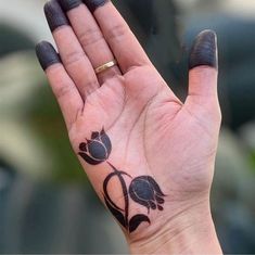 a woman's hand with a tattoo on it holding her palm up to the camera