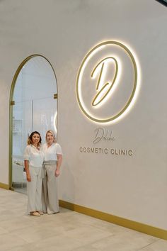 two women standing next to each other in front of a sign that says dolce cosmetic clinic