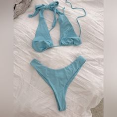 Color Truest To First Photo Bikini With Two Tops Options Beautiful Baby Blue Bright And Cute! Adjustable Ties High Waist Cheeky Bottoms Brand New Without Tags Out From Under Brand Top Size Large - Adjustable Can Fit Various Busts Second Top With Structured Bust Size Medium Also Adjustable Straps Bottoms Size Medium- Can Also Fit Small I Think Listing As Medium Size Bikini The Top Alone Was $50 The Second Top Is A Slightly Bolder Blue, You Could Even Pair With Just White Bikini Bottoms Too. Blue T-back Summer Swimwear, Blue Stretch Halter Top For Swimming, Blue Sleeveless Halter Top For Poolside, Blue T-back Halter Top For Poolside, Blue T-back Halter Top For Summer, Blue T-back Swimwear For Poolside, Blue T-back Halter Top For Beach Party, Blue Beachwear Halter Top For Vacation, Blue Halter Top For Poolside Spring Season