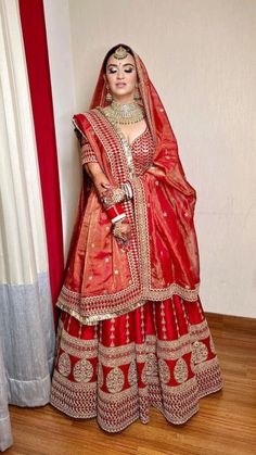 a woman in a red and gold bridal gown