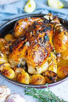 roasted chicken with potatoes and herbs in a pan