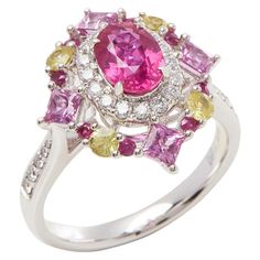 This ring designed by David Jerome is from his private collection and features one oval cut Ruby sourced in Mozambique totalling 1.30cts. Set with a mix of round brilliant cut Diamonds, pink and yellow Sapphires totalling 1.73cts combined. Mounted in platinum. Ring size UK N, EU size 54, USA size 6 1/2. David prides himself in only sourcing the finest and most exclusive gemstones whose natural beauty and colour enhance the settings he creates for each piece. These exclusive designs offer buyers Mozambique Ruby, Sapphire Cluster Ring, Vintage Cluster Ring, Ruby Diamond Rings, Contemporary Ring, Cluster Rings, Diamond Jewelry Designs, Platinum Ring, Ruby Diamond