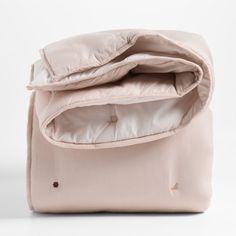 an open pink bag sitting on top of a white table