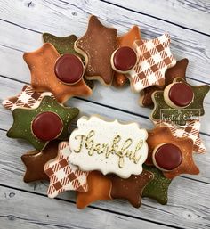 decorated cookies arranged in the shape of leaves with words thank you written on one side