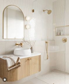 a bathroom with a sink, mirror and shower head in the middle of the room