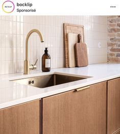 a kitchen counter with a sink, soap dispenser and cutting board