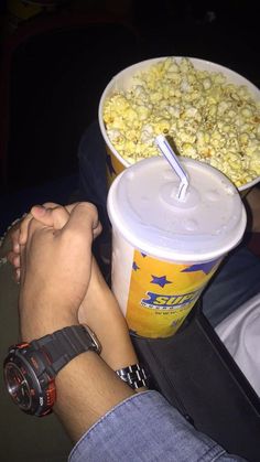 two buckets of popcorn and a person's arm