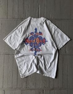 FOLLOW MY SHOP TO CHECK DAILY UPDATES & PRICE DROPS Vintage Men's Hard Rock Cafe California Tee Shirt White Short sleeve crew neck heavyweight cotton tee shirt. Big graphic print with Hard Rock Cafe logo on the front on the chest. Size XL P2P - 22'' Length - 29'' Shirt is in very good pre-owned condition and has minor flaw. Please check pictures for more information on the product Shipping options: - standard shipping in 7-15 days - priority in 3-5 business days (price will be more)   Check out my other items & follow - new arrivals every week! If you have any questions regarding the item, shipping - feel free to contact any time. All items are genuine. Customer satisfaction is our priority! Cafe Logo, Rock Tees, Rock Cafe, Hard Rock Cafe, Shirt White, Vintage Tees, Hard Rock, Vintage Men, Cotton Tee