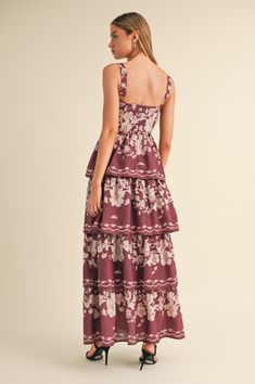 The Kyra Maxi Dress in a wine hue is your ticket to summer elegance! With its floral print, sleeveless ruched bust, and tiered design, this dress is ready to turn heads. It’s perfect for making a statement while sipping cocktails or dancing the night away. Color: Wine Self: 100% Polyester, Lining: 80% Polyester, 20% Rayon Hand wash cold, dry flat. Item #MD4733A Size/Fit Model is wearing size S. Chic Floral Print Tiered Dress For Garden Party, Chic Sleeveless Floral Print Tiered Dress, Tiered Floral Dress With Smocked Bodice For Garden Party, Summer Sleeveless Burgundy Maxi Dress, Summer Sleeveless Floral Tiered Dress, Sleeveless Floral Print Tiered Dress For Summer, Sleeveless Burgundy Maxi Dress For Summer, Sleeveless Tiered Dress With Smocked Bodice For Garden Party, Sleeveless Floral Print Tiered Dress For Brunch