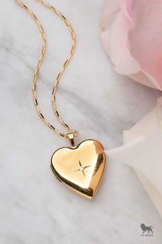 Discover our stunning 14kt Gold Filled Heart of Gold Locket, the ideal layering necklace to enhance your jewelry stack! This versatile piece can be paired with other necklaces for a bold, effortless look or worn alone for a minimalist style. Crafted with a delicate paper clip chain, this dainty yet eye-catching locket is designed to become a staple in your collection. Perfect for everyday wear or special occasions, it adds a touch of elegance to any outfit.