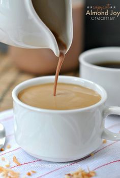 a cup of coffee being poured into it