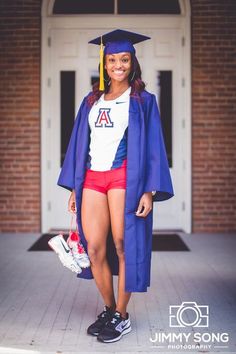 a young woman in her graduation cap and gown poses for a photo outside the school