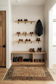 shoes are lined up against the wall in this entryway