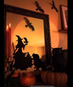 a halloween scene with an owl, witch and cat in front of a large mirror