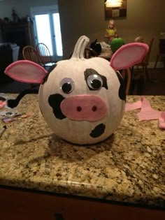 a pumpkin decorated to look like a cow