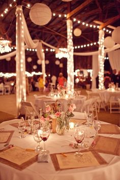 the tables are set with wine glasses and place settings for guests to sit down at