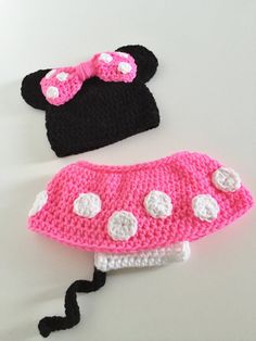 two crocheted minnie mouse hats are shown on a white surface with black and pink trim