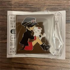 a pin with an image of a man holding a cat on it's back