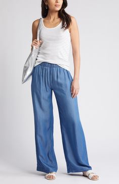 Lightweight chambray pants are cut with flowy wide legs and topped with a comfortable elastic waist. 31 1/2" inseam; 26" leg opening; 11 1/2" front rise; 15" back rise (size Medium) Elastic waist Front slant pockets; back welt pockets 100% Tencel® lyocell Tencel lyocell is a sustainably produced fiber made with closed-loop processing Machine wash, line dry Imported How To Style Flowy Pants, Chambray Pants Outfit, Trendsend Evereve, Pants Nordstrom, Best Pants, Chambray Pants, 50 Is Not Old, Womens Wide Leg Pants, Flowy Pants