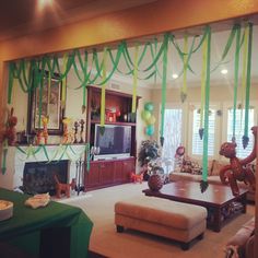 the living room is decorated with green streamers