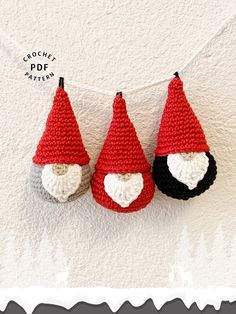 three crocheted gnome hats hanging on a string