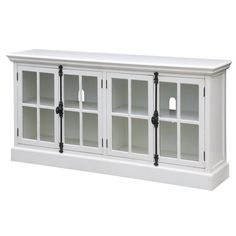 a white entertainment center with glass doors and black pipings on the bottom shelf