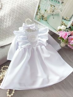 Cute white christening baby dress. ☘️The dress has long sleeve with ruffles in upper part. ☘️ The dress is decorated with the ruffle and baptism emblem. ☘️At the back side are butterfly buttons. ☘️ Dress skirt is under the knees. ☘️The dress is made with 100 proc polyester fabric and has pure cotton lining. ☘️To complete the set we add headband with the bow. This simple and elegant dress can be perfect choice for your baby baptism. Product care : Wash into 30-40 degrees water and speen carefully Baptism Baby Girl Dress, Summer Baptism Dress With Bow, Short Sleeve Baptism Dress With Bow, Customizable Cotton Sets For Baptism, Simple And Elegant Dress, Baptism Baby Girl, Cotton Baptism Sets, Suspender Shorts, White Baby Dress