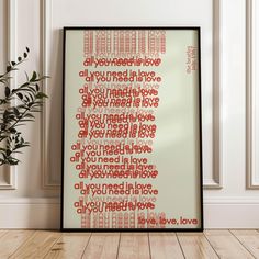 a framed poster with the words all you need is love in red and white on it