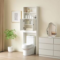 a white toilet sitting next to a bathroom sink under a mirror on top of a wooden floor