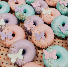 there are many doughnuts decorated with bows and pearls on the top one is blue