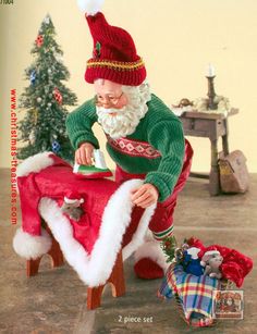 an old fashioned santa clause is decorating a christmas table