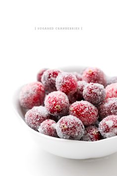 powdered cranberries in a white bowl on a white background with the words, sugared cranberries 1