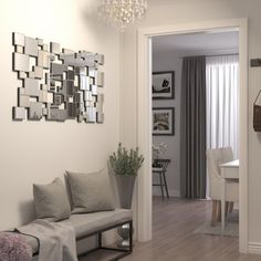 a living room filled with furniture and a chandelier hanging from the side of a wall