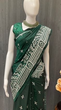 This stunning Indian Saree - Banglori Silk Bottle Green Kantha Work Saree is a must-have addition to your wardrobe. The intricate hand embroidery adds a touch of elegance and sophistication to the saree, making it perfect for any formal occasion. The fall pico has already been done, ensuring a perfect drape every time you wear it. The rich green color is sure to turn heads and make you stand out in any crowd. Add this beautiful indian saree to your collection today and feel like a true queen. No Embroidered Green Pre-draped Saree In Dola Silk, Green Embroidered Pre-draped Saree, Transitional Green Saree With Resham Embroidery, Transitional Season Green Saree With Resham Embroidery, Navratri Traditional Wear With Cutdana In Slub Silk, Traditional Festive Slub Silk Pre-draped Saree, Embroidered Art Silk Pre-draped Saree, Green Embroidered Chanderi Fabric Saree, Green Chanderi Embroidered Fabric Saree