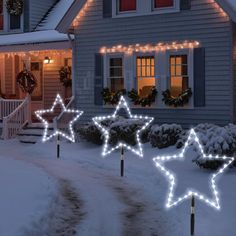 christmas lights are lit up in front of a house